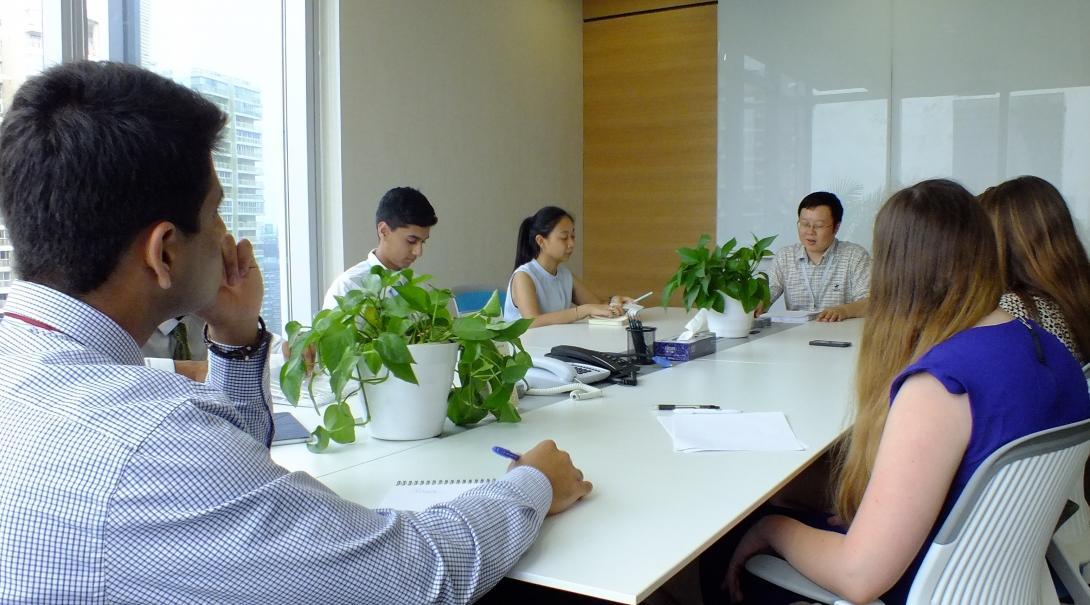 A group of teenage interns participate in a meeting with business professionals at a company in Chengdu, China. Business professionals working for a company in China involve teenage Projects Abroad interns in a meeting.
